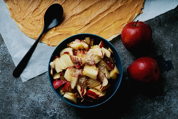 cooking process of apple swirls dough with spread peanut butter filling and cut apples with brown sugar and two apples top view flat lay - Конфеты для аллергиков