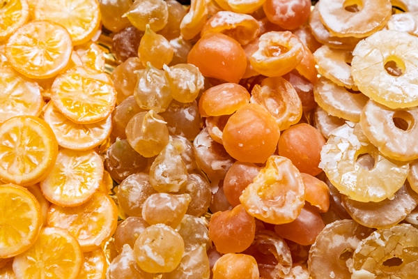 candied lemons peaches plums and pineapple fruit background selective focus - Цукаты из сливы