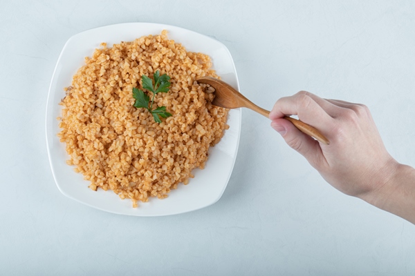 delicious bulgur pilaf on white plate - Библия о пище