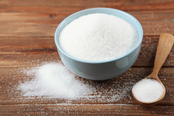 white sugar on the table on a light background closeup - Тыква в сладком маринаде