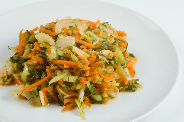 celery salad with carrot closeup on white plate salad isolated on white - Салат из сырых овощей