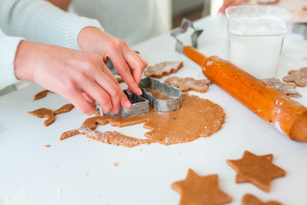 kid s hands making gingerbread cutting cookies of gingerbread dough festive food cooking process family culinary christmas and new year traditions concept - Медовые пряники