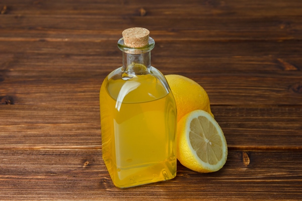 lemon juice and lemon with sliced lemon high angle view on a wooden surface copy space for - Хумус из фасоли с грибами