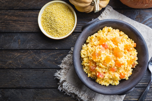 millet porridge with sweet pumpkin in a bowl rustic style healthy vegan dish top view - Пшённая каша с тыквой