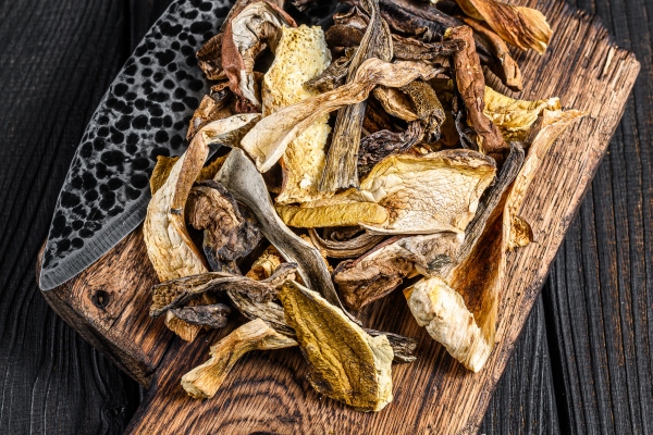 sliced porcini wild dried mushrooms on a wooden cutting board - Суп грибной, постный стол