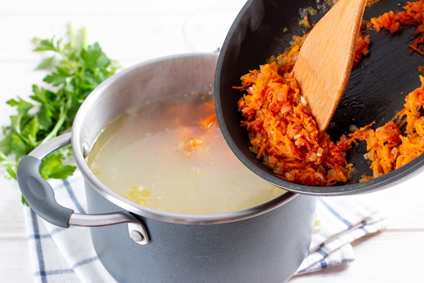 step by step preparation soup with pumpkin and vegetables step adding vegetable dressing to the broth - Суп с корневищами иван-чая