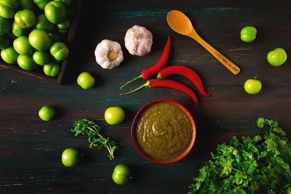 tkemali sauce traditional georgian cuisine green cherry plum on a wooden table closeup rustic food background no people selective focus - Соус Ткемали