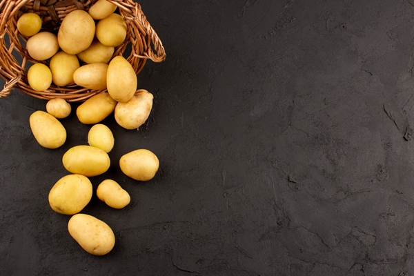 top view peeled out potatoes whole inside basket on the dark floor - Постный суп грибной с картофелем