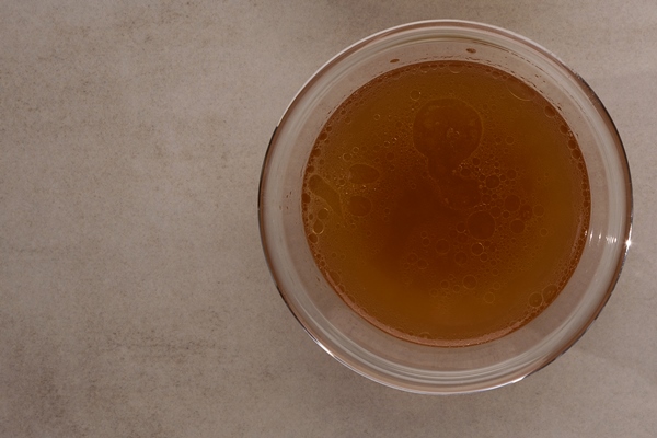 two types of bone broth in transparent cups on stone table top view close up fish and meat broth contain healthy collagen - Начинка для пирога со свежими грибами