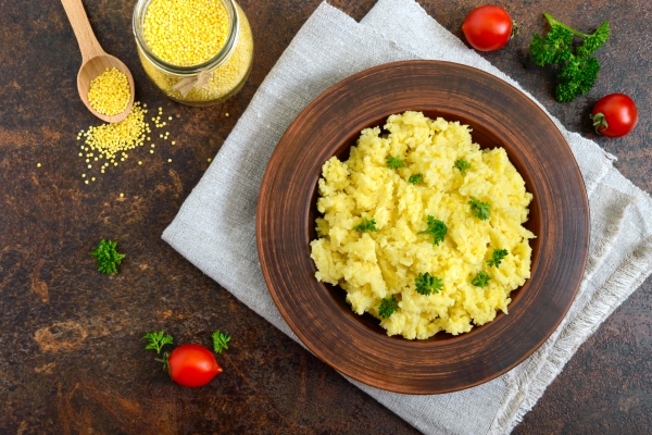 useful millet porridge in a clay bowl lenten menu vegan dishes - Каша пшённая с морковью