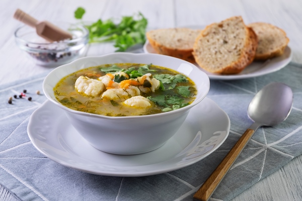 vegetarian vegetable soup with dumplings in a white porcelain plate healthy and dietary food vegetarianism selective focus close up - Постный суп грибной с галушками