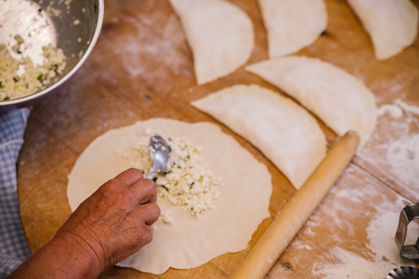 women s hands in the process of cooking kutaba or chebureks minced meat and onions in the doughcottage cheese and onion in the dough azerbaijani tatar caucasian greek cuisine - Чебуреки постные