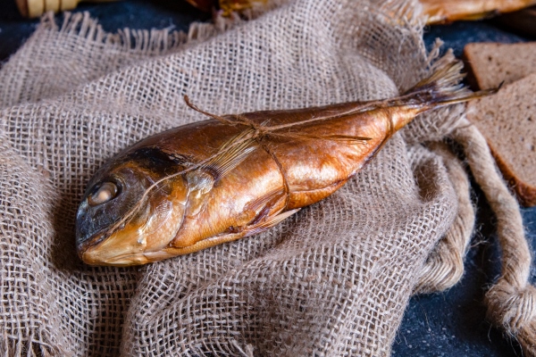 smoked whole dry fish on a piece of rustic tissue - Ботвинья по-монастырски