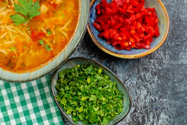 top view tasty vermicelli soup with greens on light grey table - Суп вермишелевый