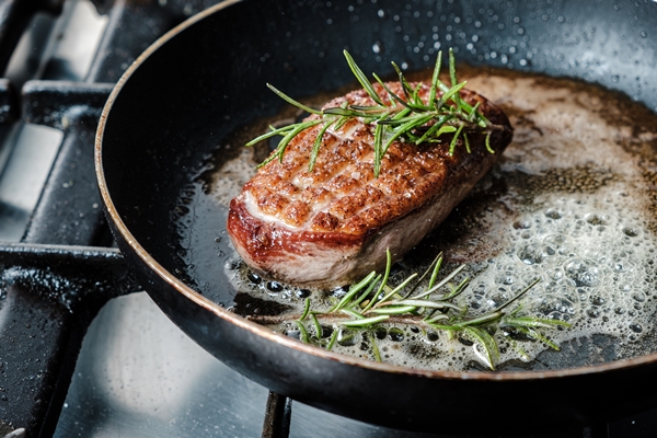 closeup shot of delicious duck breast fillet frying in a pan - Жареное мясо