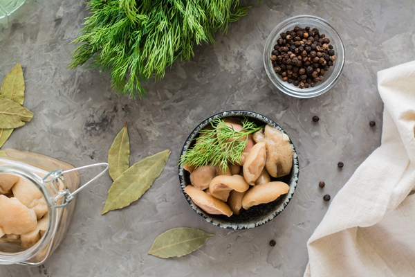 pickled mushrooms boletus in a bowl and in a glass jar on the table organic vegetarian food top view - Простой картофельный салат