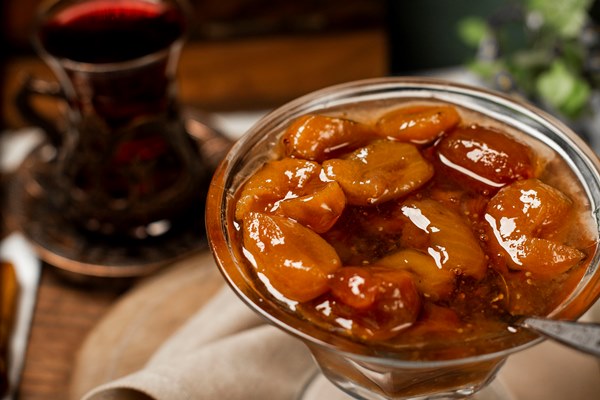 plum confiture in a glass jar on a white towel - Сливовое варенье с косточками