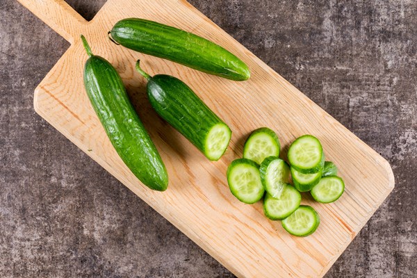 top view cucumber sliced wooden cutting board brown stone horizontal 1 - Салат с рисом и тунцом на Благовещение