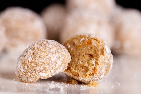 beautiful sweets with coconut on a white plate on a black background 1 - Домашние постные конфеты "Лимонные шарики"