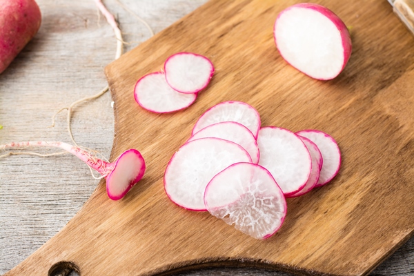 fresh sliced radish on a cutting board on a wooden table rustic style top view - Новогодние бутерброды "Ёлочка"