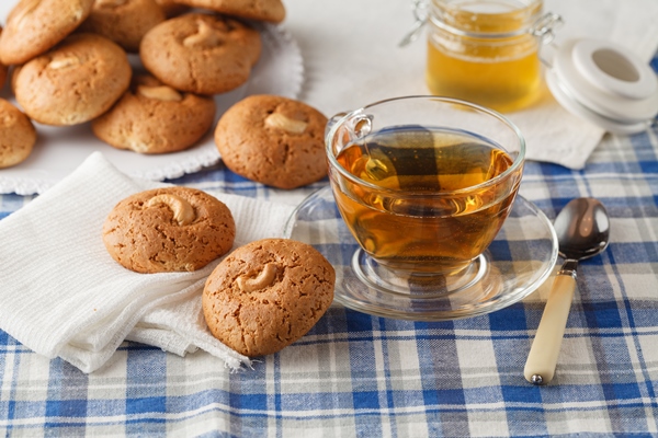 oatmeal cookies with nut jar with honey on napkin on brown wooden table food holiday cooking baking concept of home and healthy eating - Постные прянички из битого теста