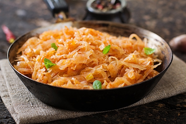 stewed cabbage on the old wooden table in rustic style - Постная тушёная капуста с яблоками