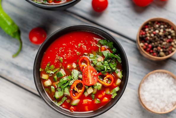 two plates of traditional spanish cold gazpacho tomato soup on wood background - Основы сухоядения