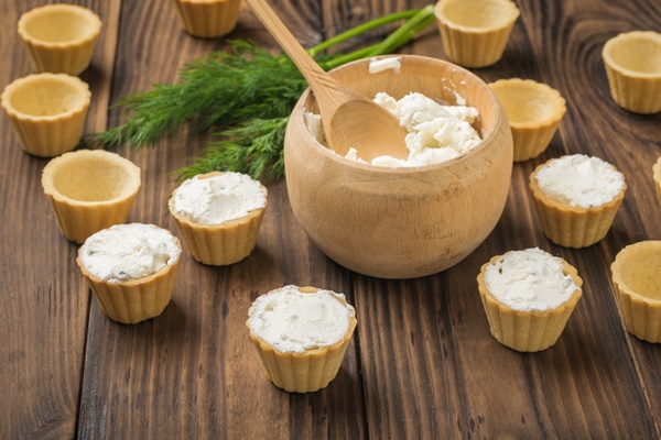 wooden bowl with cream cheese and tartlets on a wooden table the process of preparing a delicious snack - Тарталетки "Ёлочки"