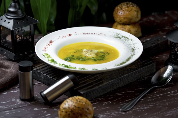 chicken broth soup with white meat inside and species - Бульон с заварными булочками