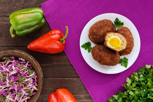 meat mini rolls with boiled egg on dark wood the top view 1 - Котлеты, фаршированные яйцом