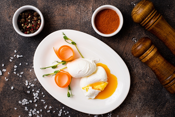 poached eggs on a white plate on a black table - Бульон с кореньями и зеленью