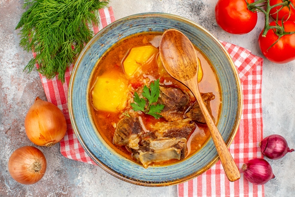 Шурпа top view homemade bozbash soup wooden spoon kitchen towel a bunch of dill tomatoes onions on nude background - Шурпа