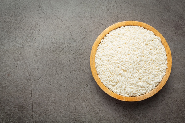 white rice on small wooden plate place on dark floor - Харчо