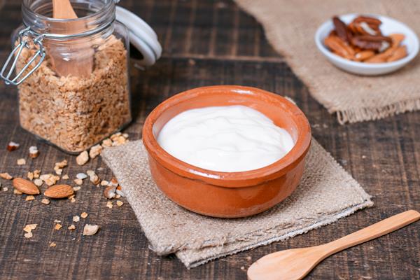 close up breakfast bowl with yogurt on the table - Творог с молодой зеленью