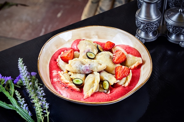 fresh homemade dumplings with cherries and berry foam in bowl traditional ukrainian cuisine ukrainian food dessert varenyky vareniki pierogi pyrohy food background with copy space sweet food - Суп из вишен с варениками