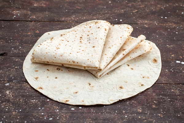 front view tasty lavash dough bread like on wooden desk breafd doough food meal - Гурийский плов