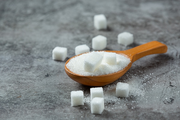 world diabetes day sugar in wooden bowl on dark surface - Сладкий молочный соус