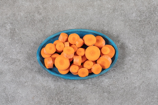 a blue wooden board full of sliced carrots placed on a stone surface - "Борщ" без варки