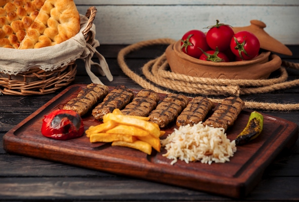 Шашлыки beef lula kebabs served with rice fried potatoes grilled tomato and peppers - Шашлыки