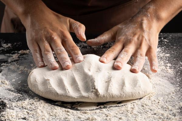 chef kneading dough on the table - Монастырская кухня: густой суп из чечевицы и тыквы, лепёшки с зеленым луком