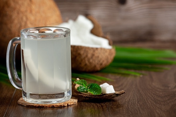 glass of coconut water put on dark wooden background - Гречнево-кокосовая каша без варки