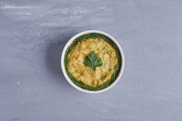 hummus in a white cup with herbs in the center - Хумус из пророщенной гречки