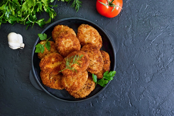 juicy homemade cutlets beef pork chicken on a black background the top view - Монастырская кухня: рисовые котлеты с грибным соусом