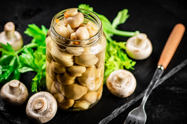 pickled mushrooms jar with greens stone board - Грибы маринованные без варки