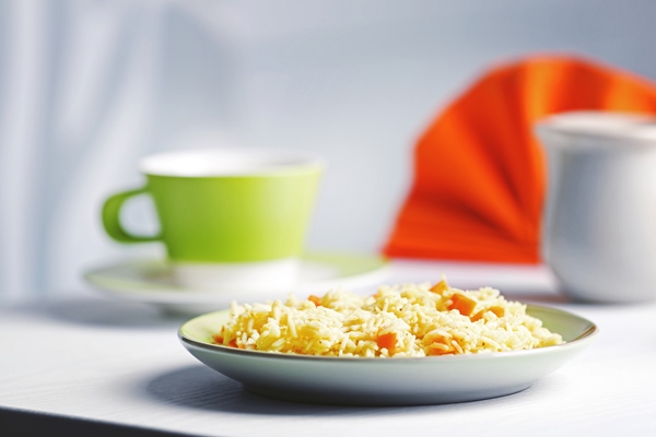 stewed rice with a carrot on a plate - Каша-мешанка по-монастырски