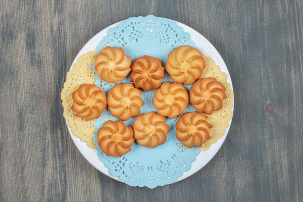 sweet delicious browned shortbread cookies in a white plate - Монастырское печенье курабье
