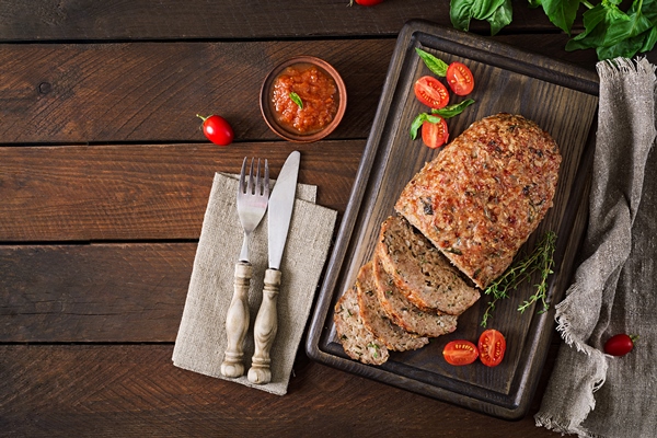 tasty homemade ground baked turkey meatloaf on wooden table - Мясной рулет с макаронами