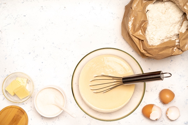 the process of making dough for pancakes with ingredients on a light table eggs and flour are whipped with a mixer 3 - Разноцветные блинцы