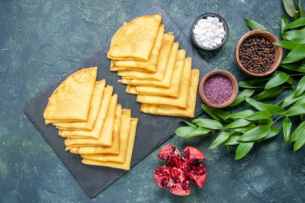 top view delicious pancakes on blue surface - Налистники