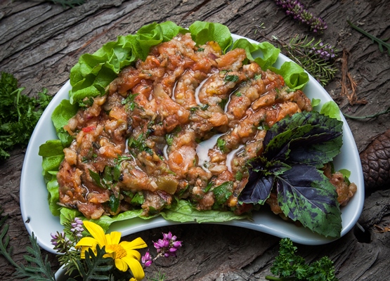 top view eggplant caviar with lettuce basil in a white plate - Закуска из баклажанов по-монастырски